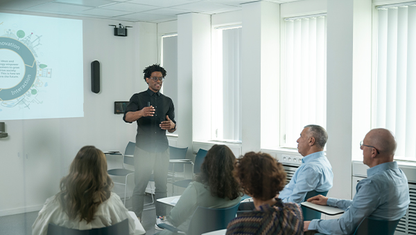 A confident man presenting the Group purpose to his team.