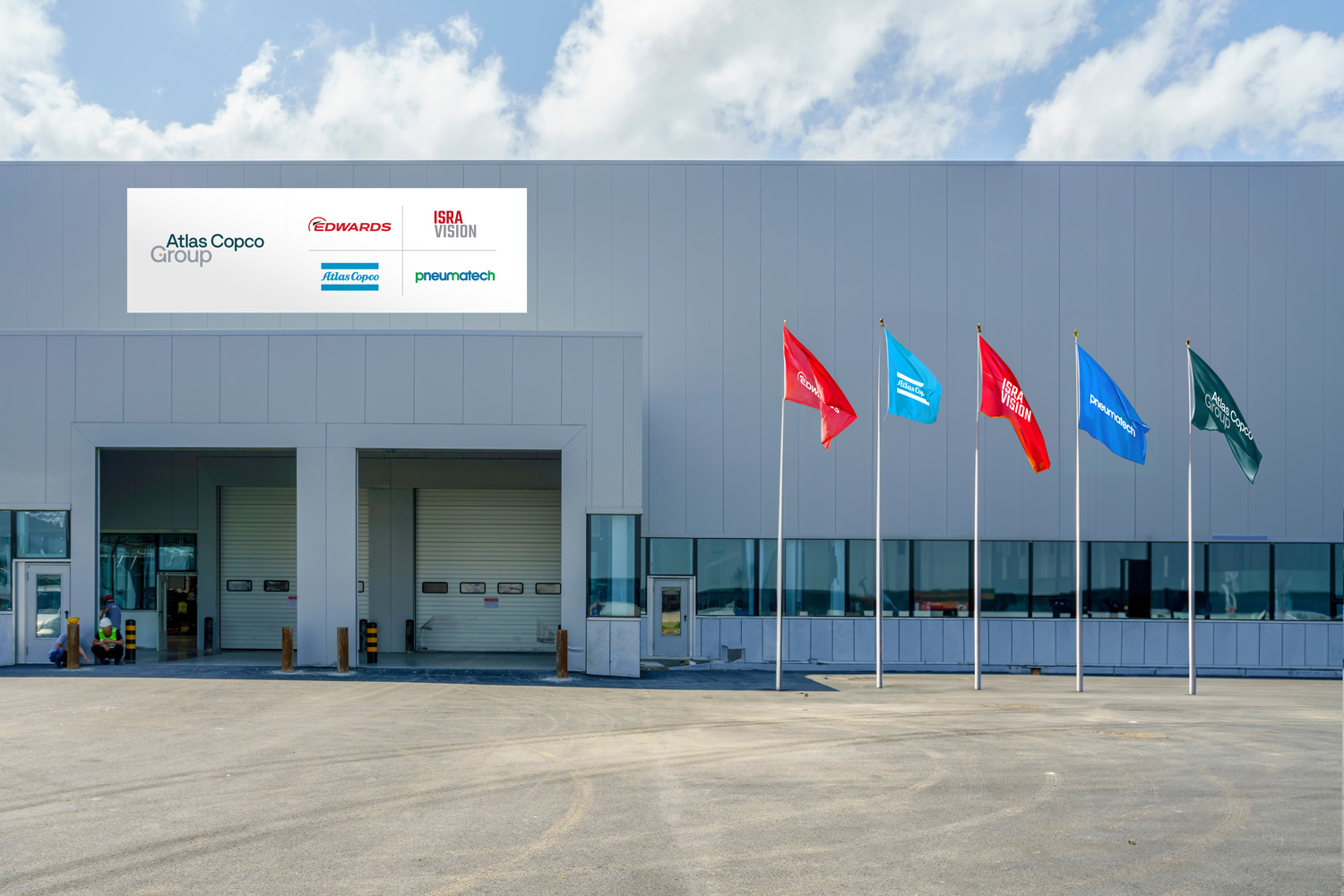 Façade of a facility showing logotypes of Group and other Group brands on the façade and on flags