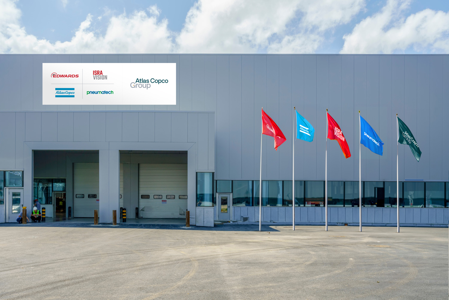 Façade of a facility showing logotypes of Group and other Group brands on the façade and on flags