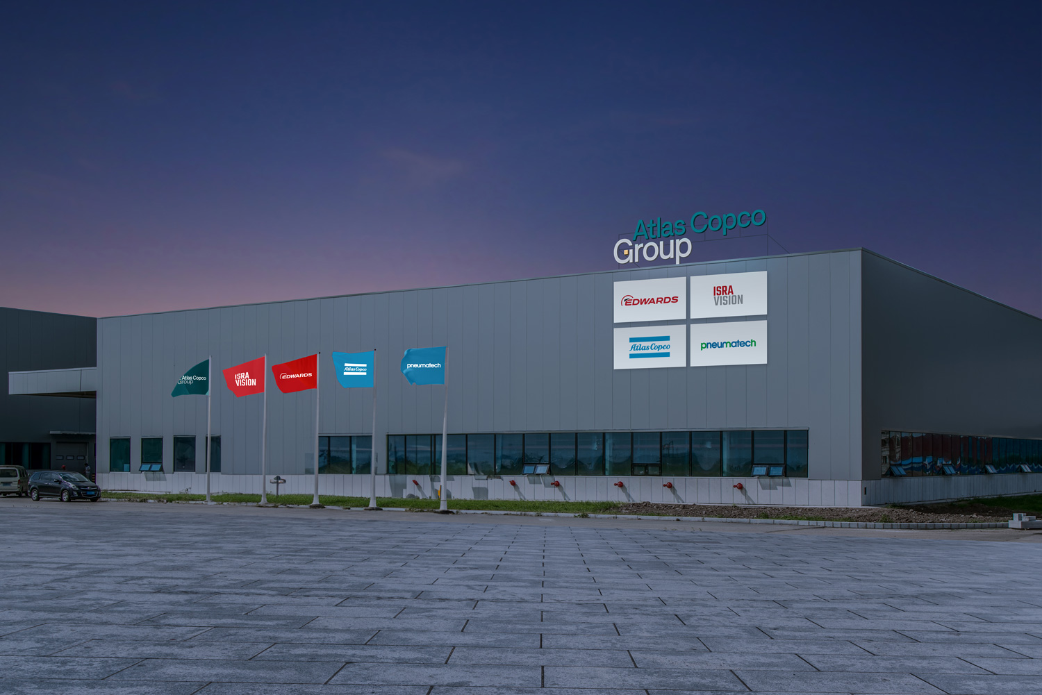 Facility branding showing the Atlas Copco Group signage on the roof