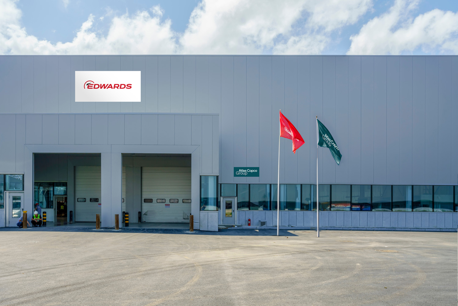 Atlas Copco Group flags in teal and white, free space marked distinctly
